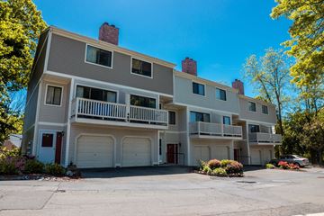 New Haven apartment for rent - A large apartment building with a parking lot in front.