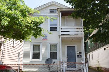 New Haven apartment for rent - A two-story house with a blue door and a balcony.