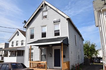 New Haven apartment for rent - A two-story house with a car parked in front.