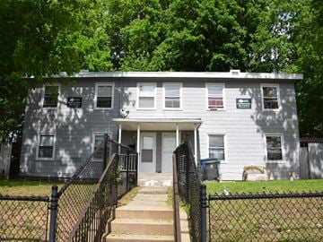 New Haven apartment for rent - A grey house with a black fence in front.