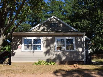 New Haven apartment for rent - A small house with a grey siding and a brown roof.