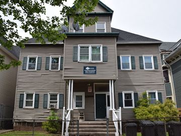 New Haven apartment for rent - A two-story house with a front porch and a garage door.