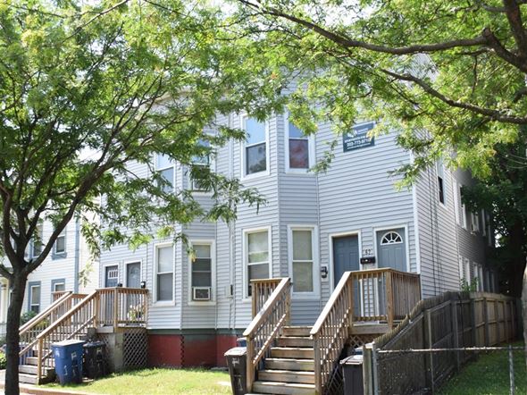 New Haven apartment for rent - A tree is in front of a grey building.