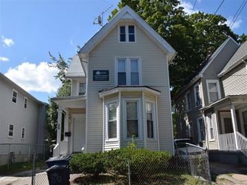 New Haven apartment for rent - A white house with a blue trash can in front of it.
