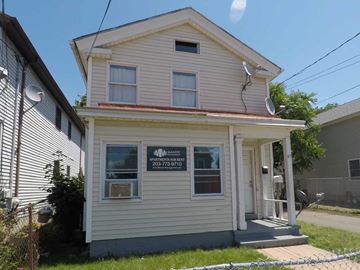 New Haven apartment for rent - A two-story house with a sign that says "BASKETBALL APARTMENTS FOR RENT".