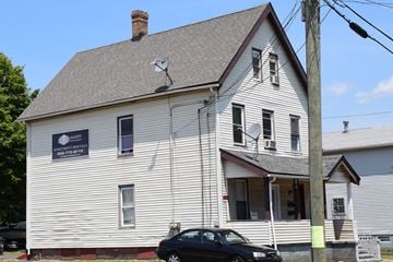 New Haven apartment for rent - A white house with a black car parked in front.