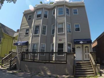 New Haven apartment for rent - A building with a blue awning and a white door.