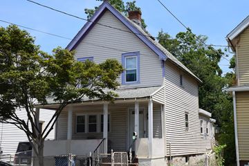 New Haven apartment for rent - A house with a purple window and a tree in front.