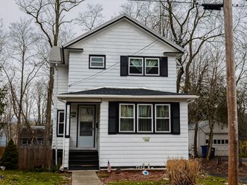 New Haven apartment for rent - A white house with a grey door and a small porch.
