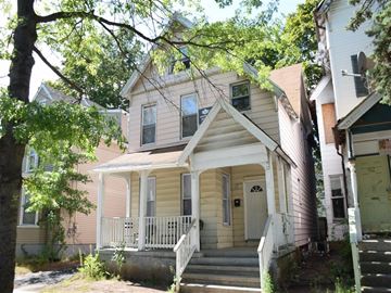 New Haven apartment for rent - A house with a white porch and a brown door.