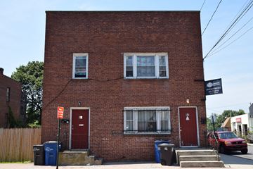 New Haven apartment for rent - A red brick building with a sign that says "Apartments" on the top right corner.