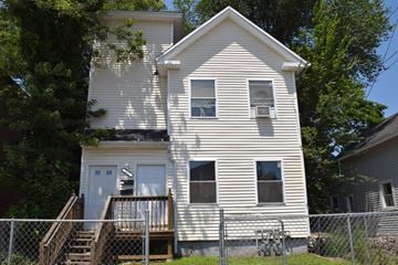 New Haven apartment for rent - A white house with a porch and a fence.