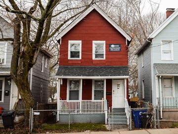 New Haven apartment for rent - A red house with a white fence in front of it.