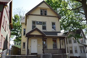 New Haven apartment for rent - A yellow house with a white door and windows.