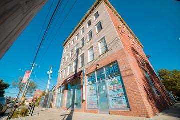 New Haven apartment for rent - A brick building with a blue sign on the front.