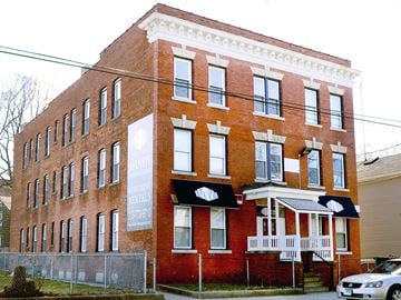 New Haven apartment for rent - A red brick building with a white sign on the front.