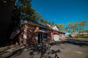 New Haven apartment for rent - A small building with a red awning and an American flag hanging on the left side.