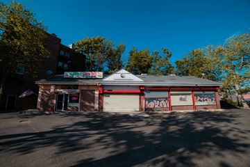 New Haven apartment for rent - A building with graffiti on the garage doors.