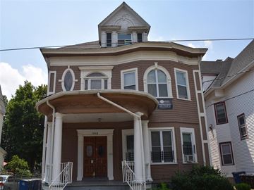 New Haven apartment for rent - A brown building with a porch and a sign on it.