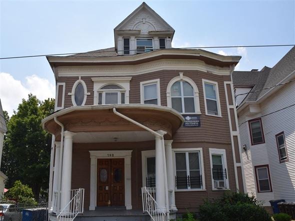 New Haven apartment for rent - A brown building with a porch and a sign on it.