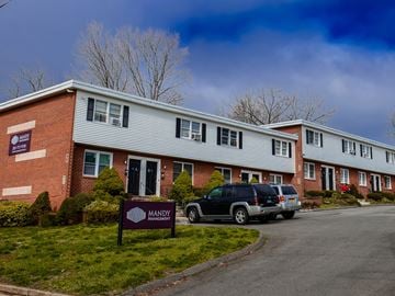 New Haven apartment for rent - a building with a sign in front of it and a car parked outside