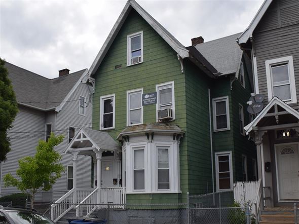New Haven apartment for rent - A green house with a white door and windows.