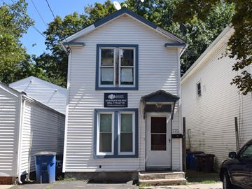 New Haven apartment for rent - A white house with a black roof and a sign on the front.