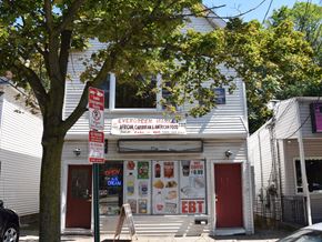 New Haven apartment for rent - A storefront with a sign that says "Open 24 Hours" and "African Caribbean American Food".