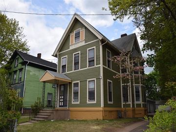New Haven apartment for rent - A green house with a brown door and windows.