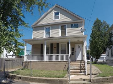 New Haven apartment for rent - A two-story house with a porch and a fence.