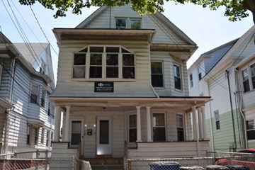 New Haven apartment for rent - A house with a sign that says "For Sale" is in front of other houses.