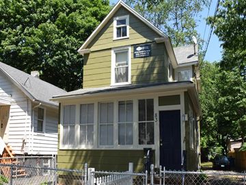 New Haven apartment for rent - A green house with a blue door and a sign on the window.