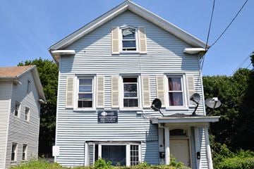 New Haven apartment for rent - A blue house with a sign that says "Welcome to the neighborhood" on the front.