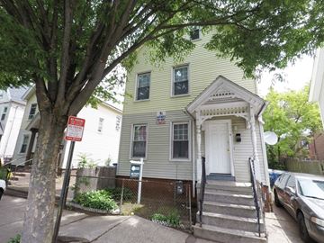 New Haven apartment for rent - A house with a white door and a sign on a pole.