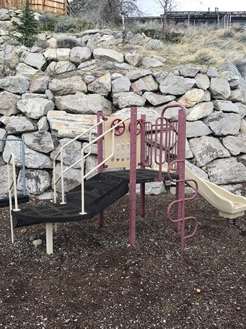 Reno apartment for rent - A playground with a slide and a climbing frame.