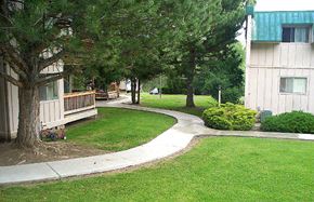 John Day apartment for rent - a sidewalk in front of a building with trees