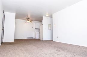 Kenosha apartment for rent - an empty living room with white walls and a ceiling fan