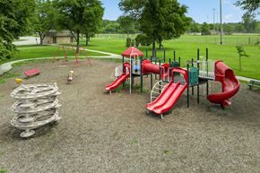 Kenosha apartment for rent - A playground with a red slide and a green slide.