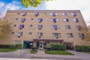 Oak Park apartment for rent - a large brick building with windows and a sidewalk in front of it