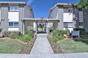 San Jose apartment for rent - The image shows a pathway leading to a building with a sign