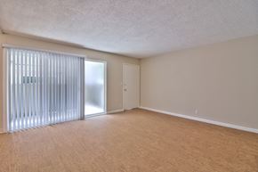 San Jose apartment for rent - A room with wooden flooring and a sliding door with blinds.