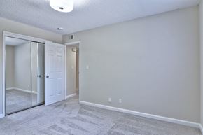 San Jose apartment for rent - A room with a carpeted floor and a white door.