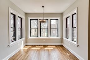 Chicago apartment for rent - an empty living room with windows and wood floors