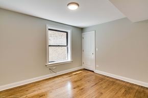 Chicago apartment for rent - an empty living room with a window and a door