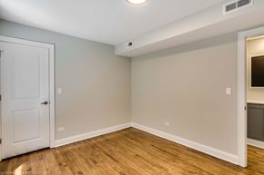 Chicago apartment for rent - an empty room with a white door and wood flooring