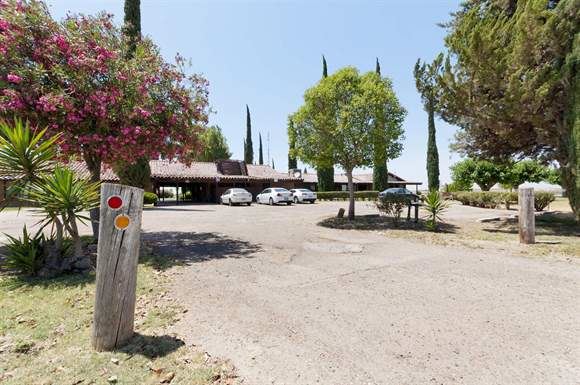 Delano apartment for rent - a parking lot with cars in front of a building