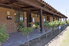 Delano apartment for rent - a building with a porch and trees in front of it