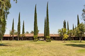Delano apartment for rent - a large grass field with trees and a house