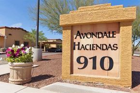 Avondale apartment for rent - a sign for a hacienda with a pot of flowers