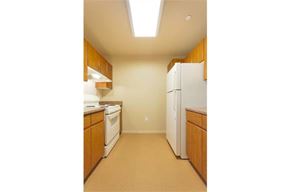 Avondale apartment for rent - a kitchen with white appliances and wooden cabinets